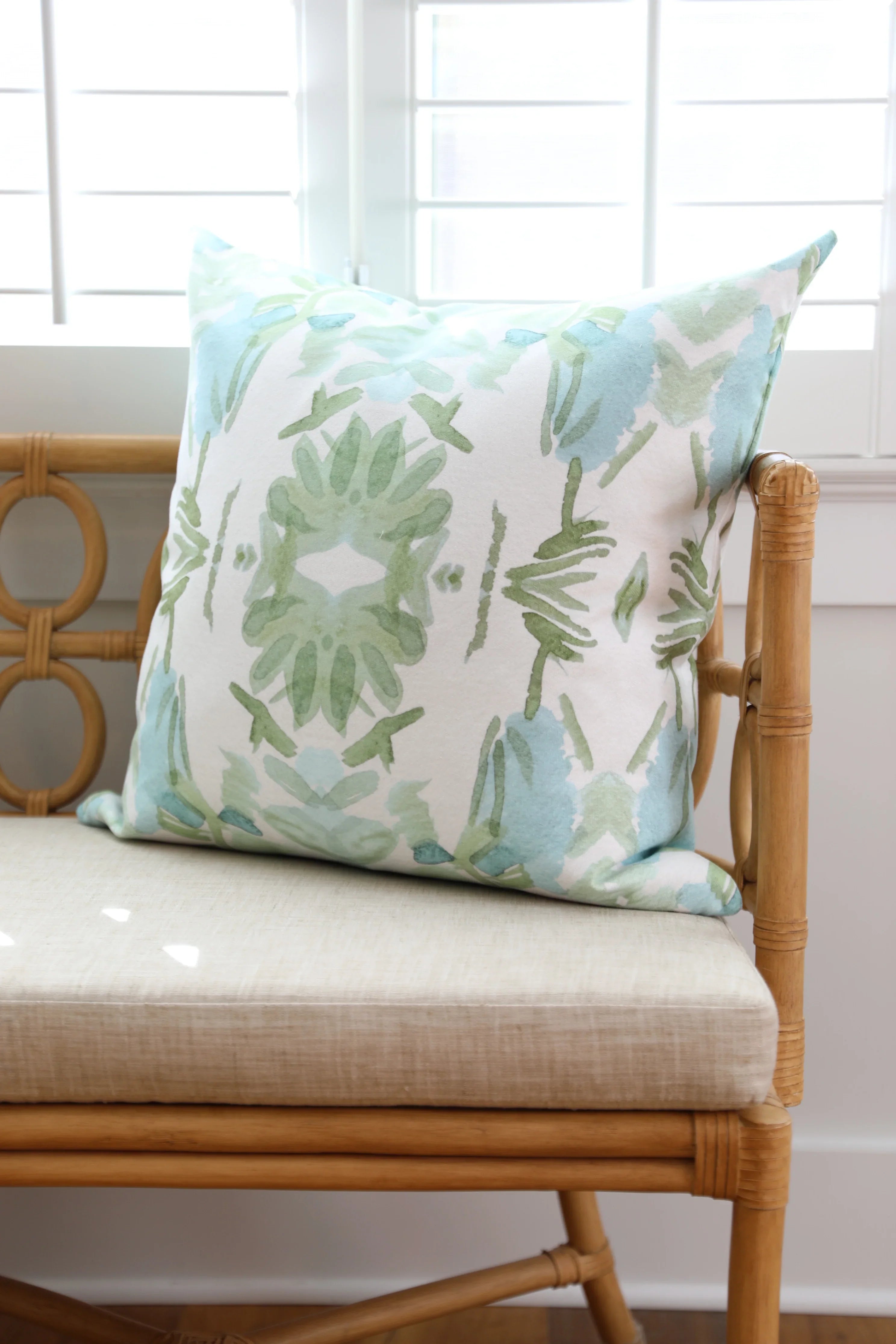 Luxury sage green and blue botanical pillow with large-scale floral pattern inspired by Alaska wildflowers, handcrafted in England and styled for contemporary and traditional interiors.