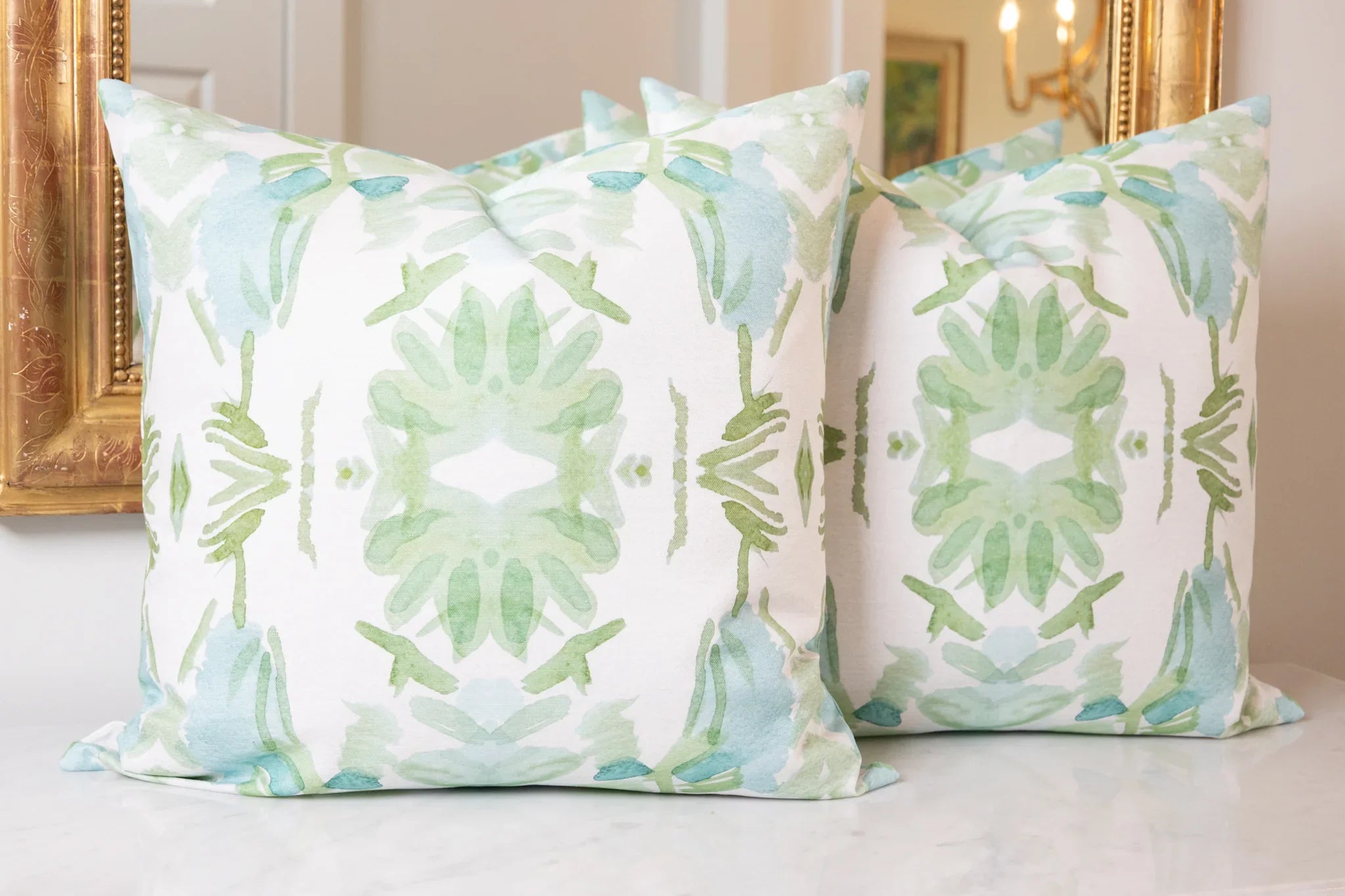 Luxury sage green and powder blue botanical pillow with large-scale floral pattern inspired by Alaska wildflowers, handcrafted in England and styled for contemporary and traditional interiors.