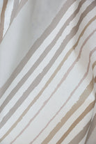 Brother Stripe in Neutrals Luxury Fabric by Truett Designs featuring an artistic stripe pattern in warm neutral tones. Handcrafted in England from sustainably printed luxury fabric, this designer fabric offers a refined foundation for layered interiors, bringing subtle structure, texture, and timeless elegance to sofas, beds, accent chairs, banquettes, and window seats. A favorite for interior designers, this versatile stripe pairs effortlessly with florals, botanicals, plaids, grasscloth wallcov