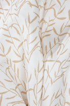 Luxury botanical fabric in warm brass tones with layered painterly organic design, ideal for upholstery, drapery, and sophisticated contemporary interiors.
