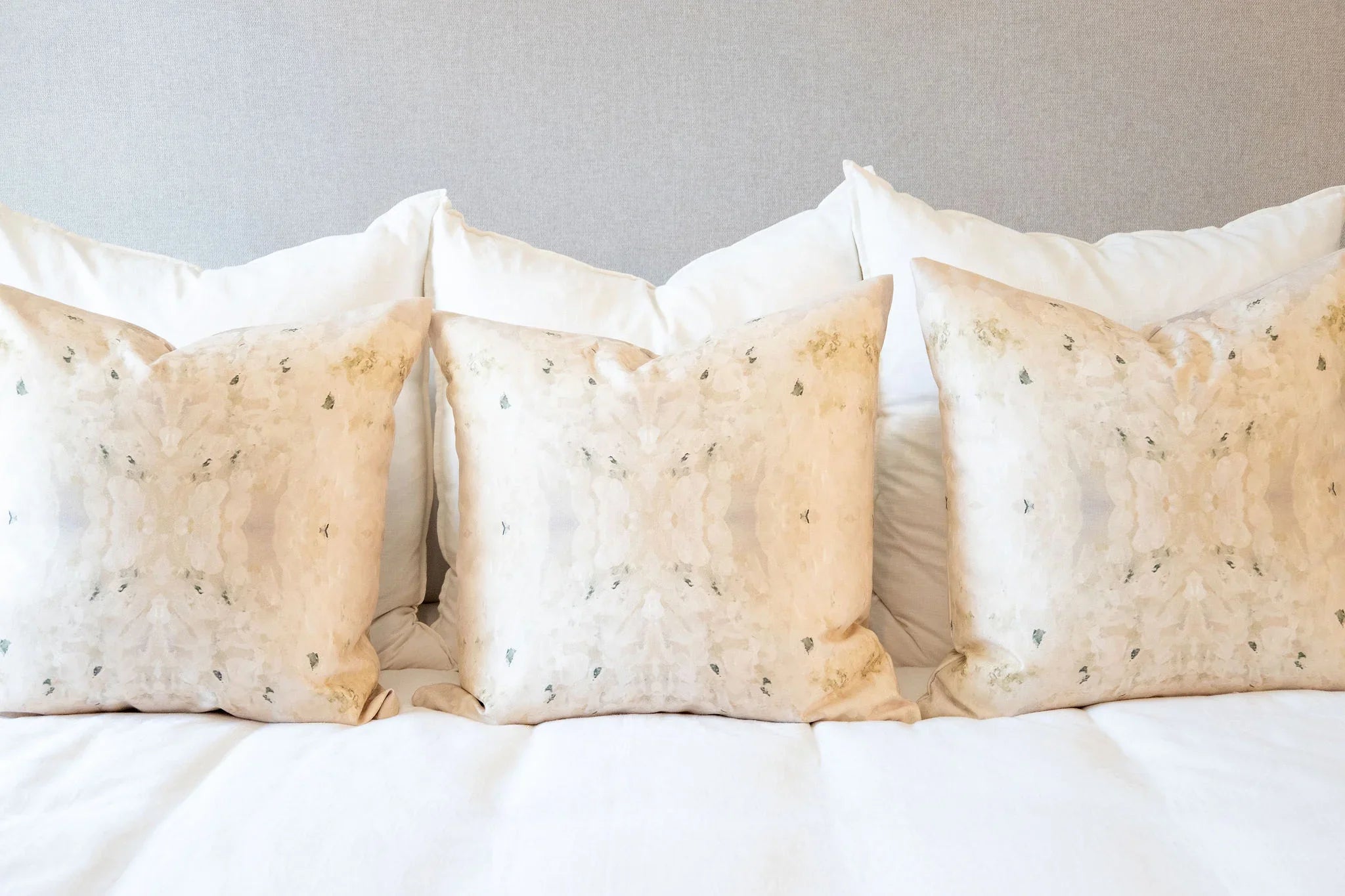 Centerpiece White Hydrangea luxury decorative pillow featuring a large-scale abstract floral pattern in layered white, cream, and deep olive green tones, handcrafted in England for luxury living rooms, designer-curated interiors, tailored upholstery, and thoughtfully layered homes.
