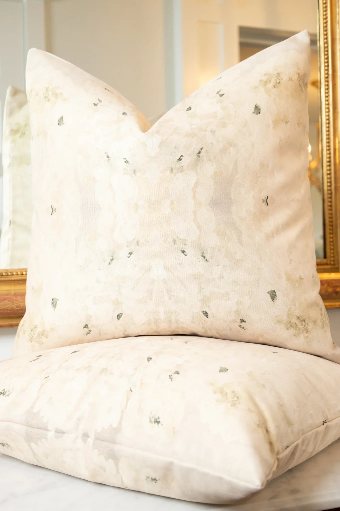 Centerpiece White Hydrangea luxury decorative pillow featuring a large-scale abstract floral pattern in layered white, cream, and deep olive green tones, handcrafted in England for luxury living rooms, designer-curated interiors, tailored upholstery, and thoughtfully layered homes.