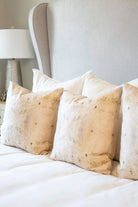 Centerpiece White Hydrangea luxury decorative pillow featuring a large-scale abstract floral pattern in layered white, cream, and deep olive green tones, handcrafted in England for luxury living rooms, designer-curated interiors, tailored upholstery, and thoughtfully layered homes.