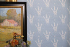 Luxury botanical wallpaper featuring a blue and white eucalyptus pattern, perfect for modern traditional interiors, coastal homes, powder rooms, bedrooms, and collected spaces.