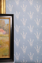 Luxury botanical wallpaper featuring a blue and white eucalyptus pattern, perfect for modern traditional interiors, coastal homes, powder rooms, bedrooms, and collected spaces.