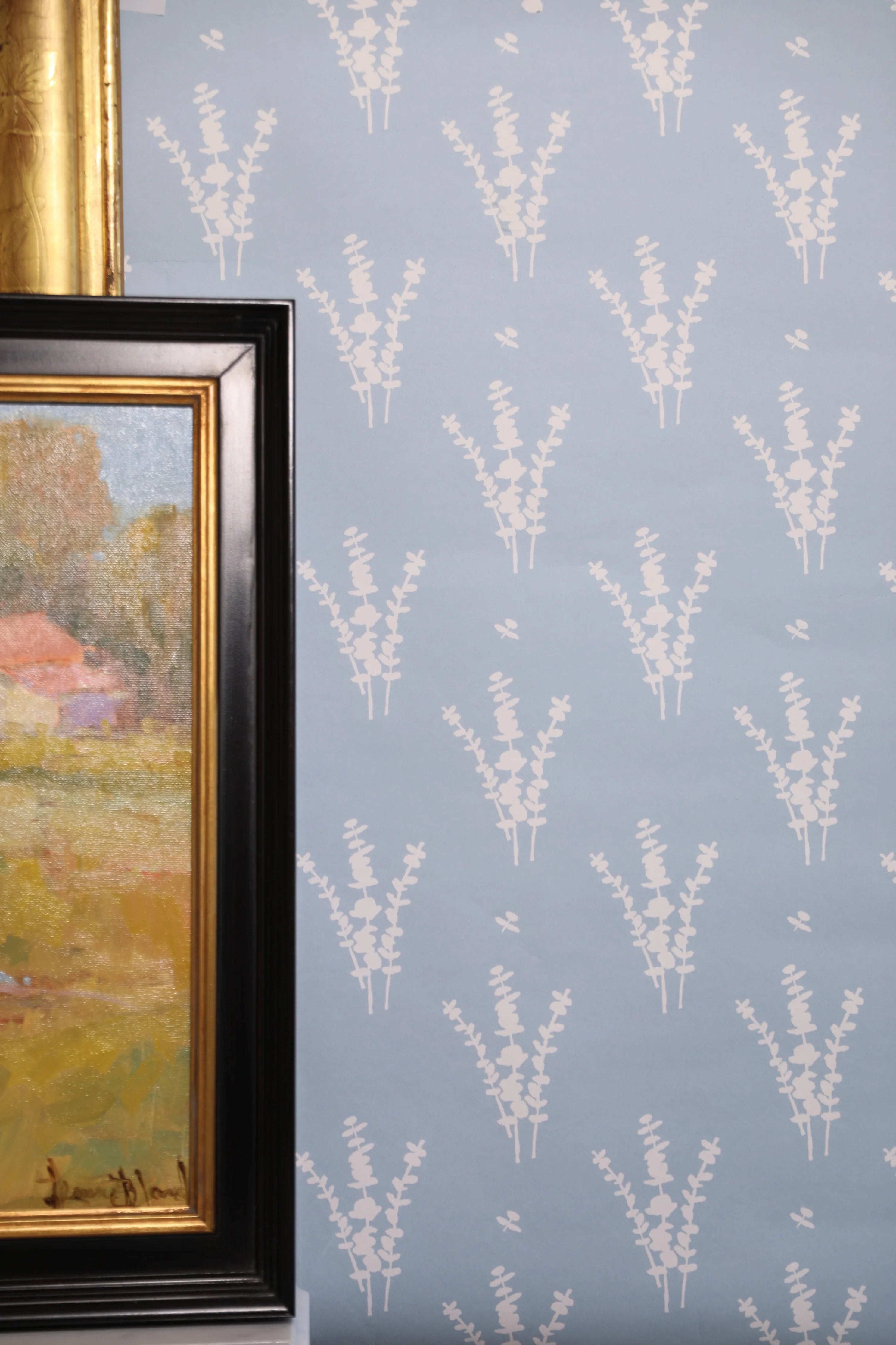 Luxury botanical wallpaper featuring a blue and white eucalyptus pattern, perfect for modern traditional interiors, coastal homes, powder rooms, bedrooms, and collected spaces.