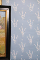 Luxury botanical wallpaper featuring a blue and white eucalyptus pattern, perfect for modern traditional interiors, coastal homes, powder rooms, bedrooms, and collected spaces.