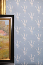 Luxury botanical wallpaper featuring a blue and white eucalyptus pattern, perfect for modern traditional interiors, coastal homes, powder rooms, bedrooms, and collected spaces.