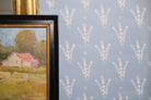 Luxury botanical wallpaper featuring a blue and white eucalyptus pattern, perfect for modern traditional interiors, coastal homes, powder rooms, bedrooms, and collected spaces.