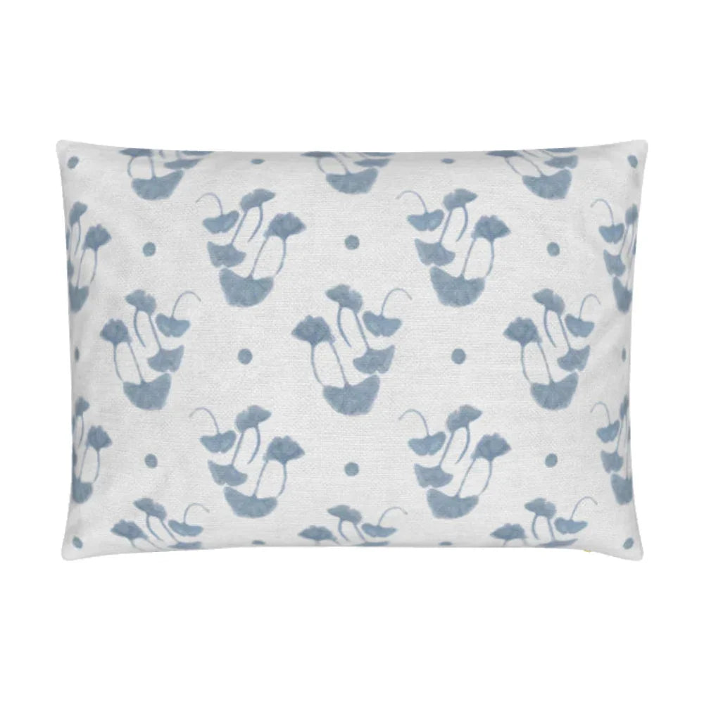 Luxury decorative pillow featuring flowing ginkgo leaf patterns in colonial blue and soft neutral tones, styled for a layered modern traditional interior.