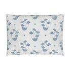 Luxury decorative pillow featuring flowing ginkgo leaf patterns in colonial blue and soft neutral tones, styled for a layered modern traditional interior.