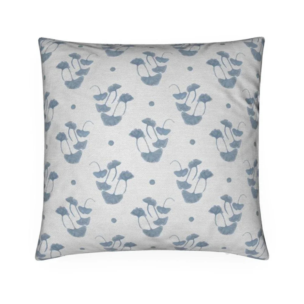 Luxury decorative pillow featuring flowing ginkgo leaf patterns in colonial blue and soft neutral tones, styled for a layered modern traditional interior.