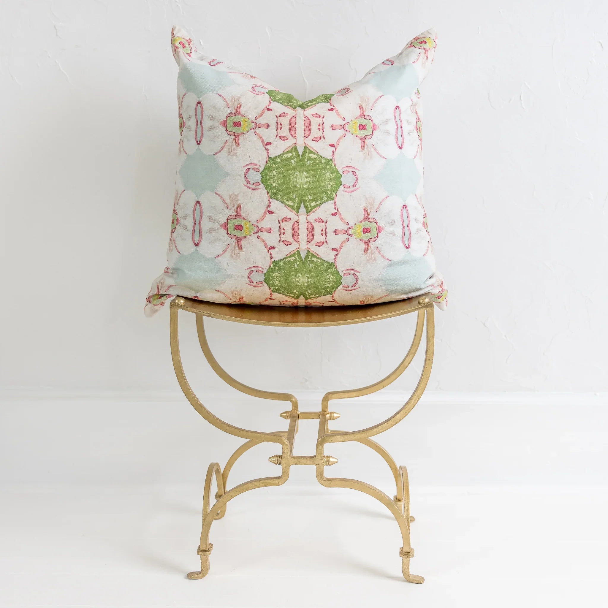 Pink Dogwoods luxury pillow featuring a large-scale abstract floral pattern in pink, soft blue, and grass green tones, handcrafted in England for layered designer interiors and luxury homes.