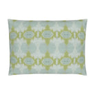 Luxury decorative pillow featuring an abstract small repeat pattern in chartreuse green and soft blue tones, styled for a layered modern traditional interior.