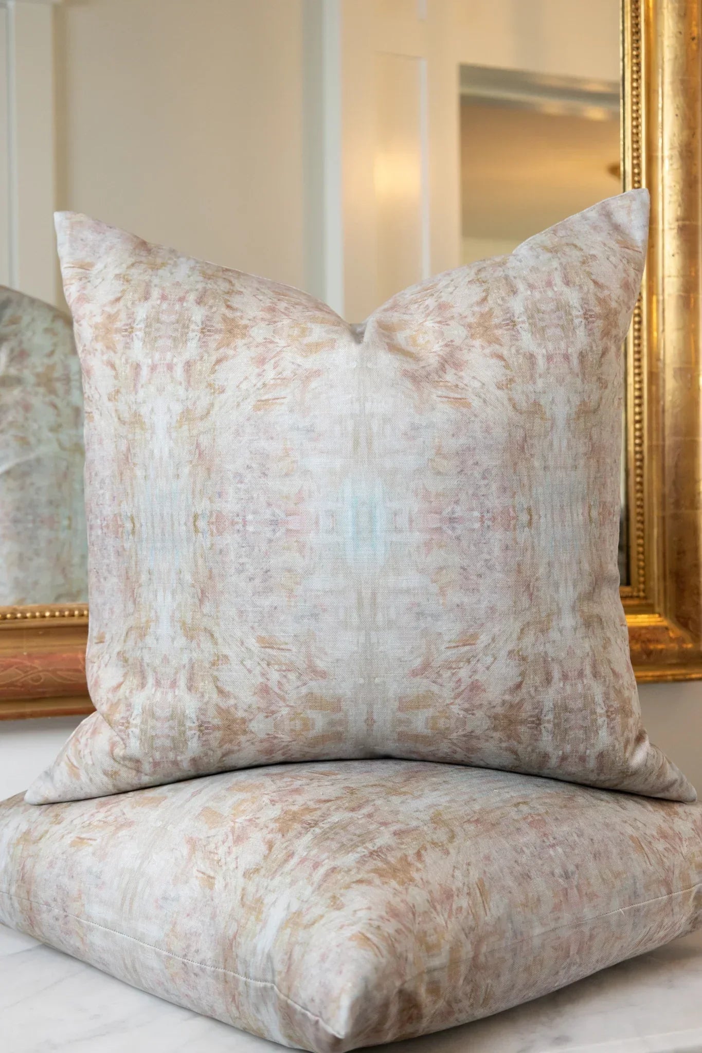 The Gardens Bronze Iris luxury decorative pillow featuring an abstract floral pattern with layered artistic movement and rich bronze, plum, and earthy tones, handcrafted in England for luxury living rooms, designer-curated interiors, thoughtfully layered spaces, and modern traditional homes.