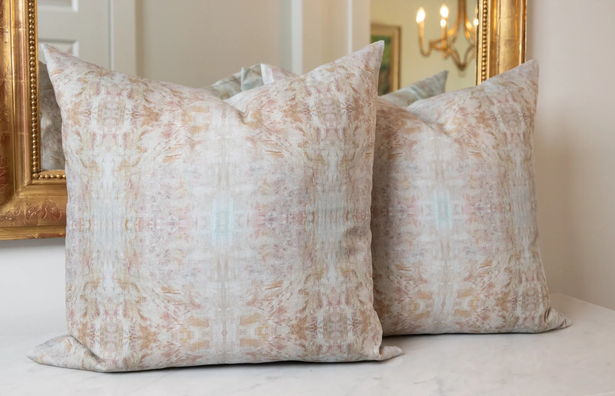 The Gardens Bronze Iris luxury decorative pillow featuring an abstract floral pattern with layered artistic movement and rich bronze, plum, and earthy tones, handcrafted in England for luxury living rooms, designer-curated interiors, thoughtfully layered spaces, and modern traditional homes.