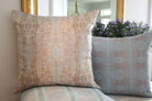The Gardens Bronze Iris luxury decorative pillow featuring an abstract floral pattern with layered artistic movement and rich bronze, plum, and earthy tones, handcrafted in England for luxury living rooms, designer-curated interiors, thoughtfully layered spaces, and modern traditional homes.