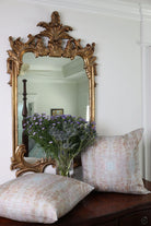 The Gardens Bronze Iris luxury decorative pillow featuring an abstract floral pattern with layered artistic movement and rich bronze, plum, and earthy tones, handcrafted in England for luxury living rooms, designer-curated interiors, thoughtfully layered spaces, and modern traditional homes.