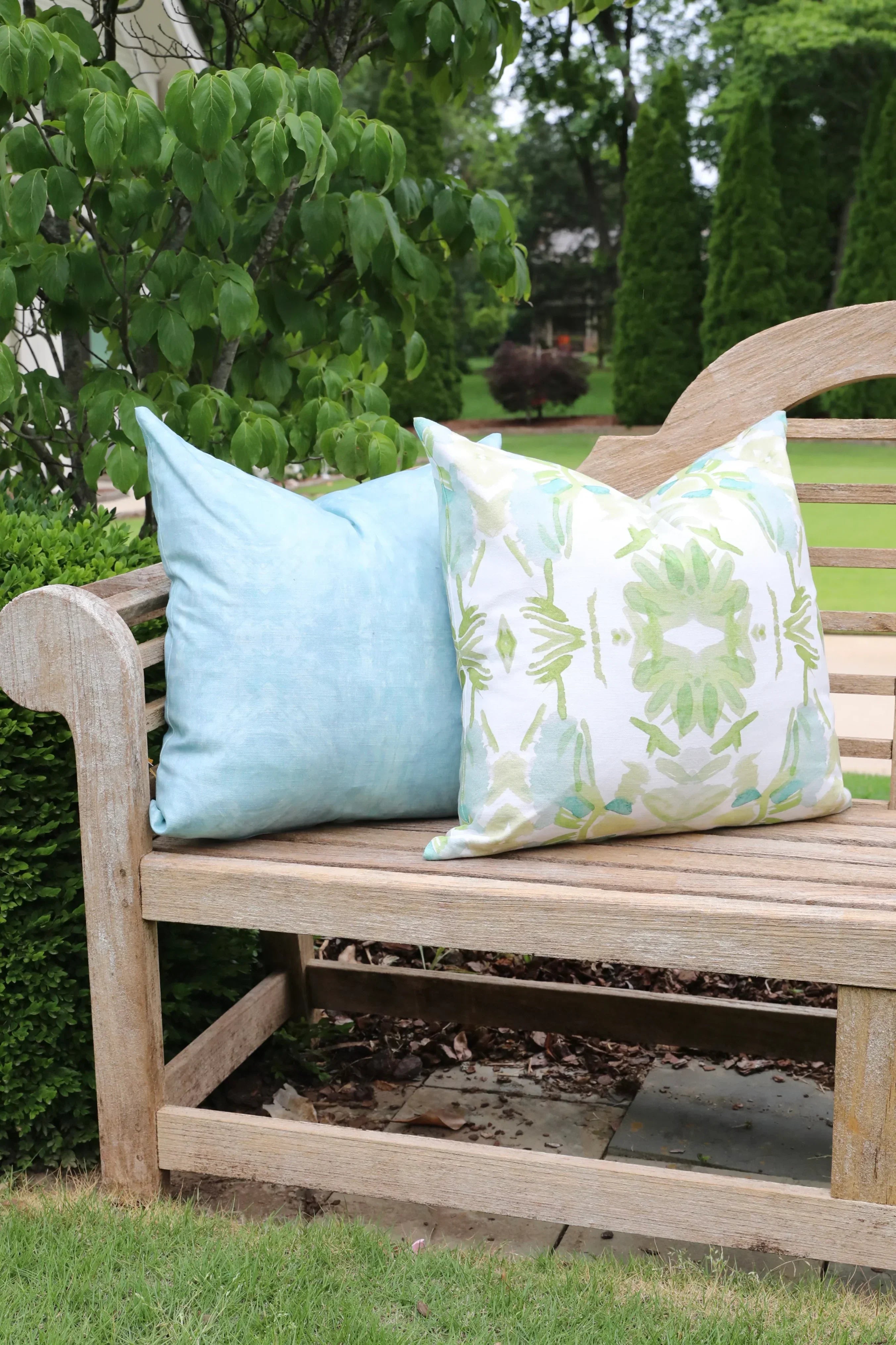 Luxury white and apple green botanical pillow with large-scale floral pattern inspired by Alaska wildflowers, handcrafted in England for contemporary and traditional interiors.