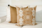 Luxury decorative pillow featuring an organic tree-inspired pattern in warm cognac and neutral tones, styled for a layered modern traditional interior.