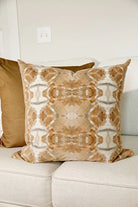 Luxury decorative pillow featuring an organic tree-inspired pattern in warm cognac and neutral tones, styled for a layered modern traditional interior.