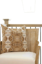 Luxury decorative pillow featuring an organic tree-inspired pattern in warm cognac and neutral tones, styled for a layered modern traditional interior.