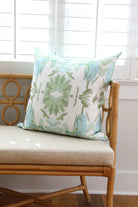 Luxury sage green and powder blue botanical pillow with large-scale floral pattern inspired by Alaska wildflowers, handcrafted in England and styled for contemporary and traditional interiors.