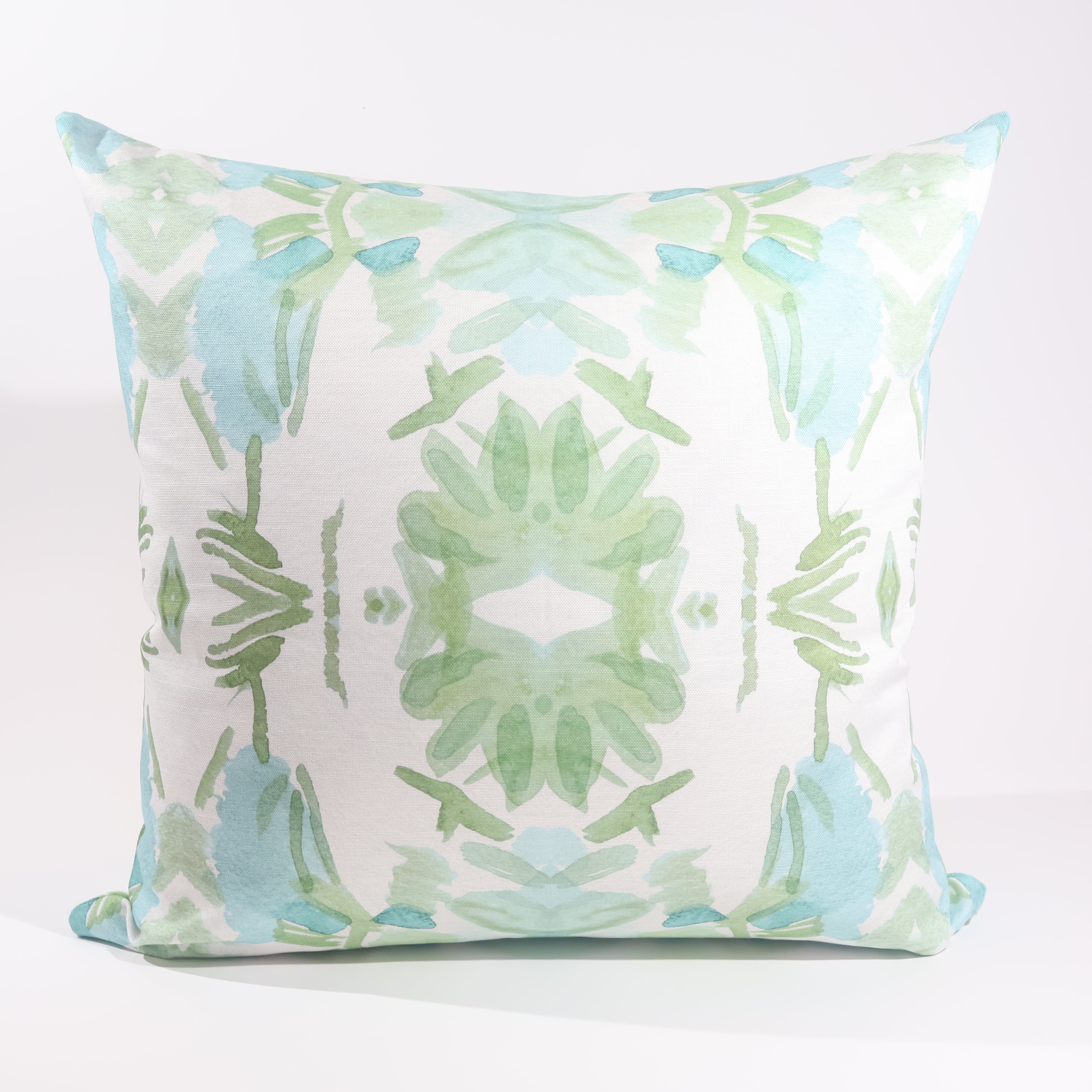 Luxury sage green and blue botanical pillow with large-scale floral pattern inspired by Alaska wildflowers, handcrafted in England and styled for contemporary and traditional interiors.