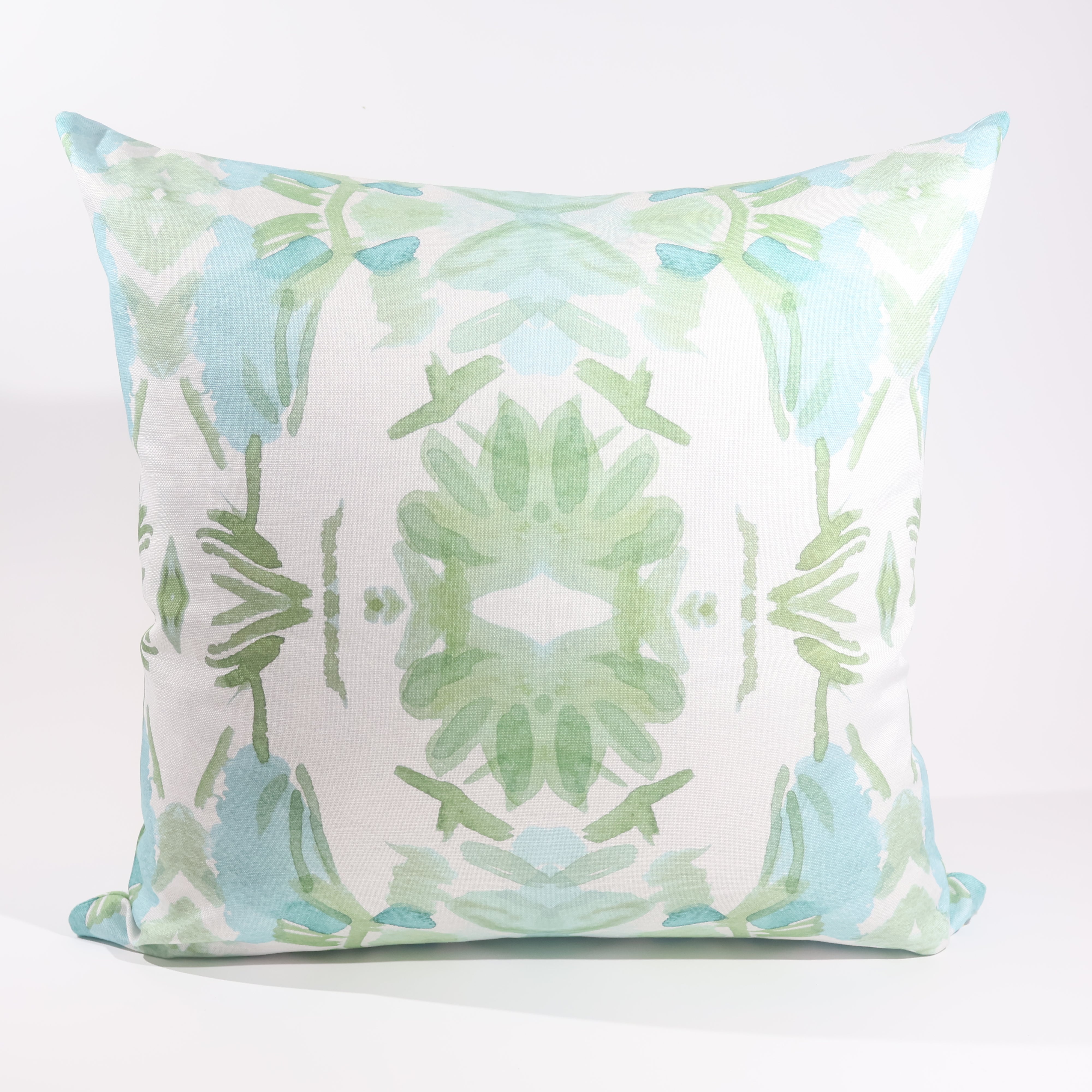Luxury sage green and blue botanical pillow with large-scale floral pattern inspired by Alaska wildflowers, handcrafted in England and styled for contemporary and traditional interiors.