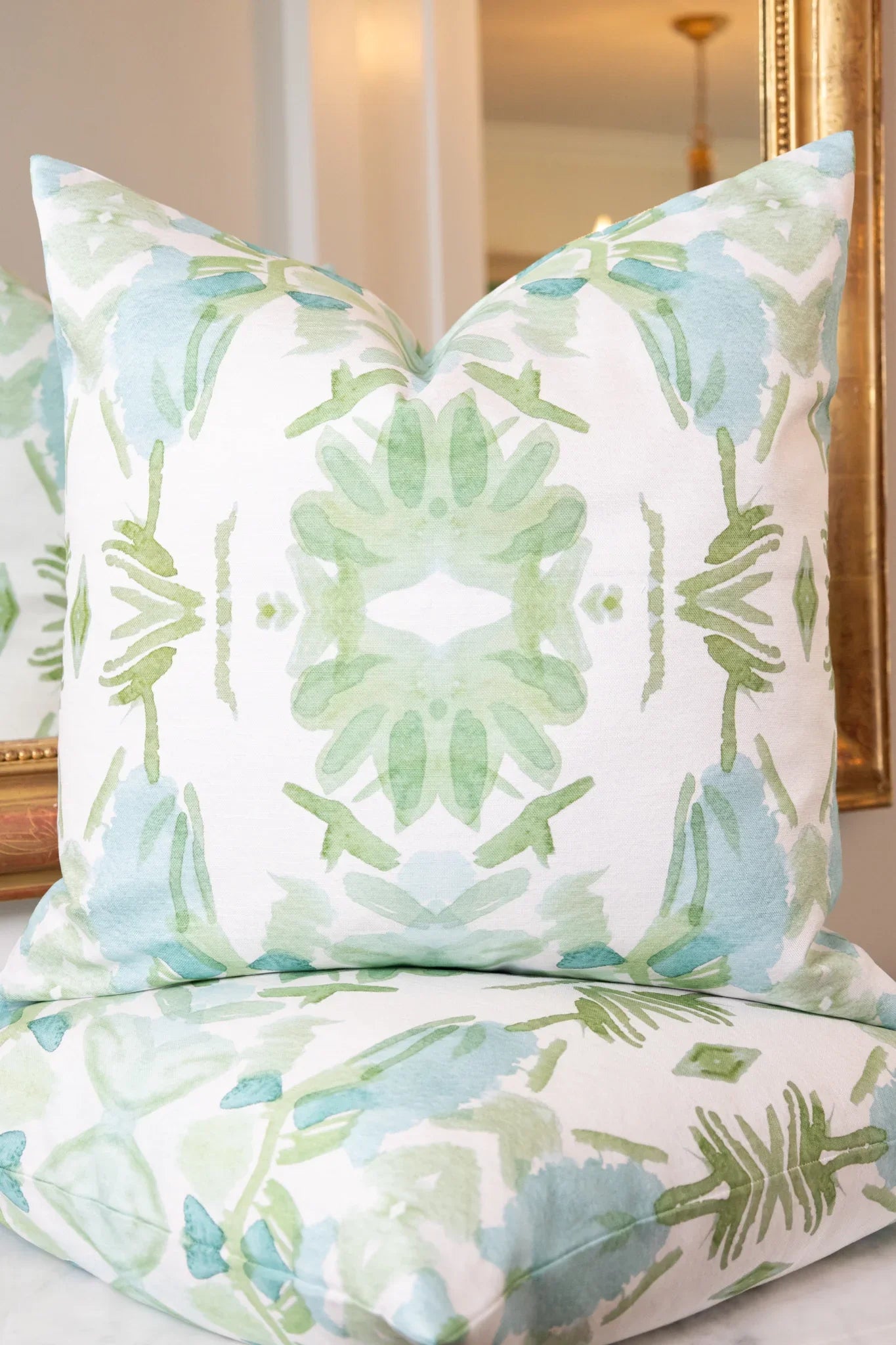 Luxury sage green and powder blue botanical pillow with large-scale floral pattern inspired by Alaska wildflowers, handcrafted in England and styled for contemporary and traditional interiors.