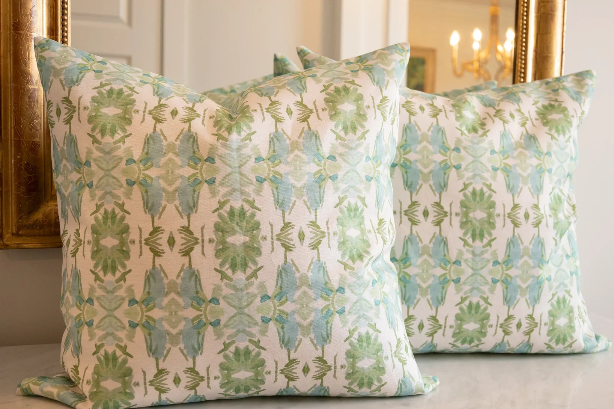 Luxury sage green and powder blue botanical pillow with large-scale floral pattern inspired by Alaska wildflowers, handcrafted in England and styled for contemporary and traditional interiors.