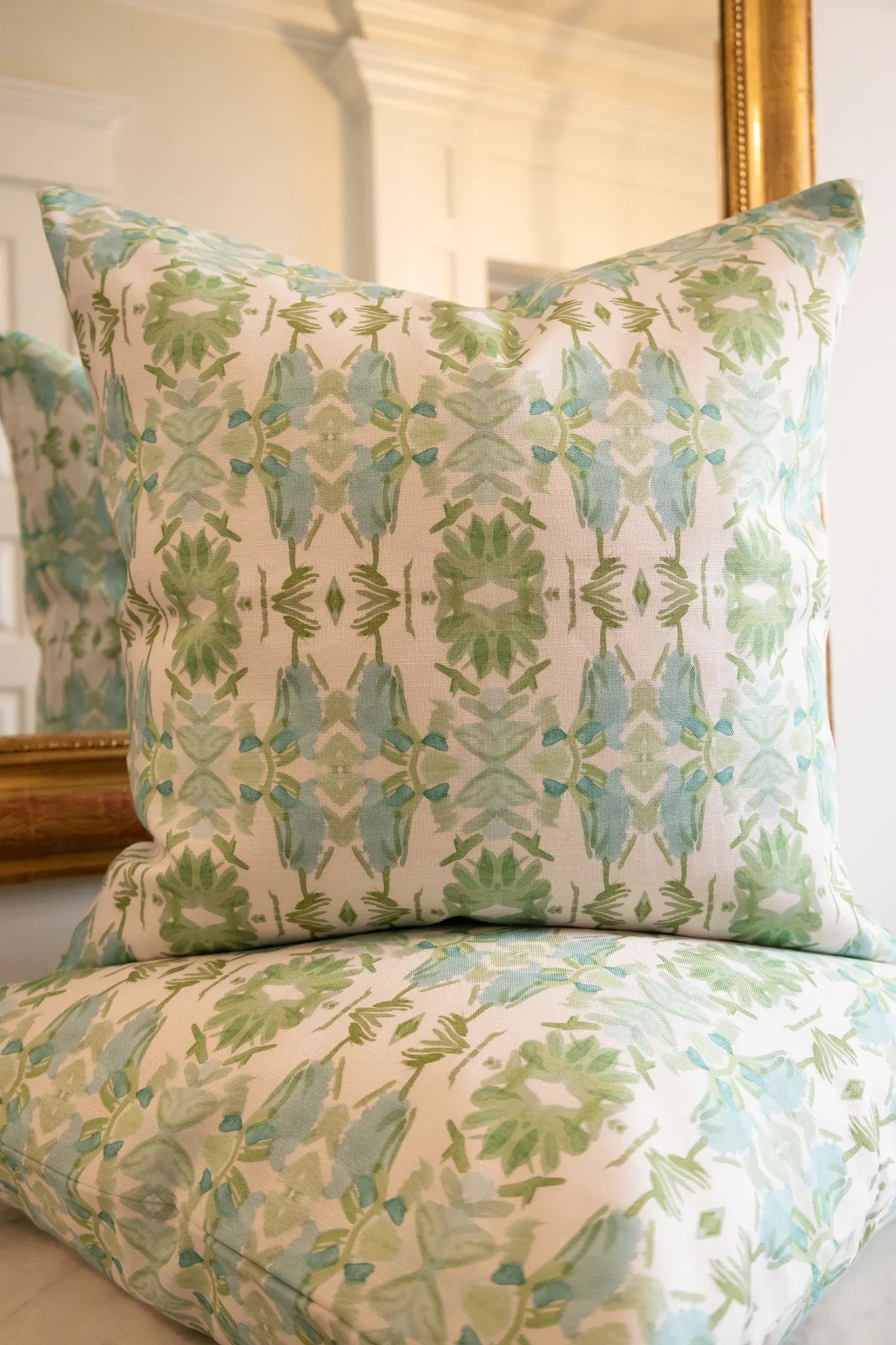 Luxury sage green and powder blue botanical pillow with large-scale floral pattern inspired by Alaska wildflowers, handcrafted in England and styled for contemporary and traditional interiors.