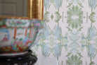 Luxury botanical wallpaper featuring an artistic wildflower-inspired pattern in sage green and soft blue, designed for modern traditional interiors, powder rooms, bedrooms, dining rooms, and collected homes.
