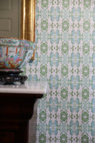 Luxury botanical wallpaper featuring an artistic wildflower-inspired pattern in sage green and soft blue, designed for modern traditional interiors, powder rooms, bedrooms, dining rooms, and collected homes.