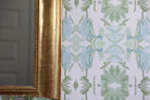 Luxury botanical wallpaper featuring an artistic wildflower-inspired pattern in sage green and soft blue, designed for modern traditional interiors, powder rooms, bedrooms, dining rooms, and collected homes.