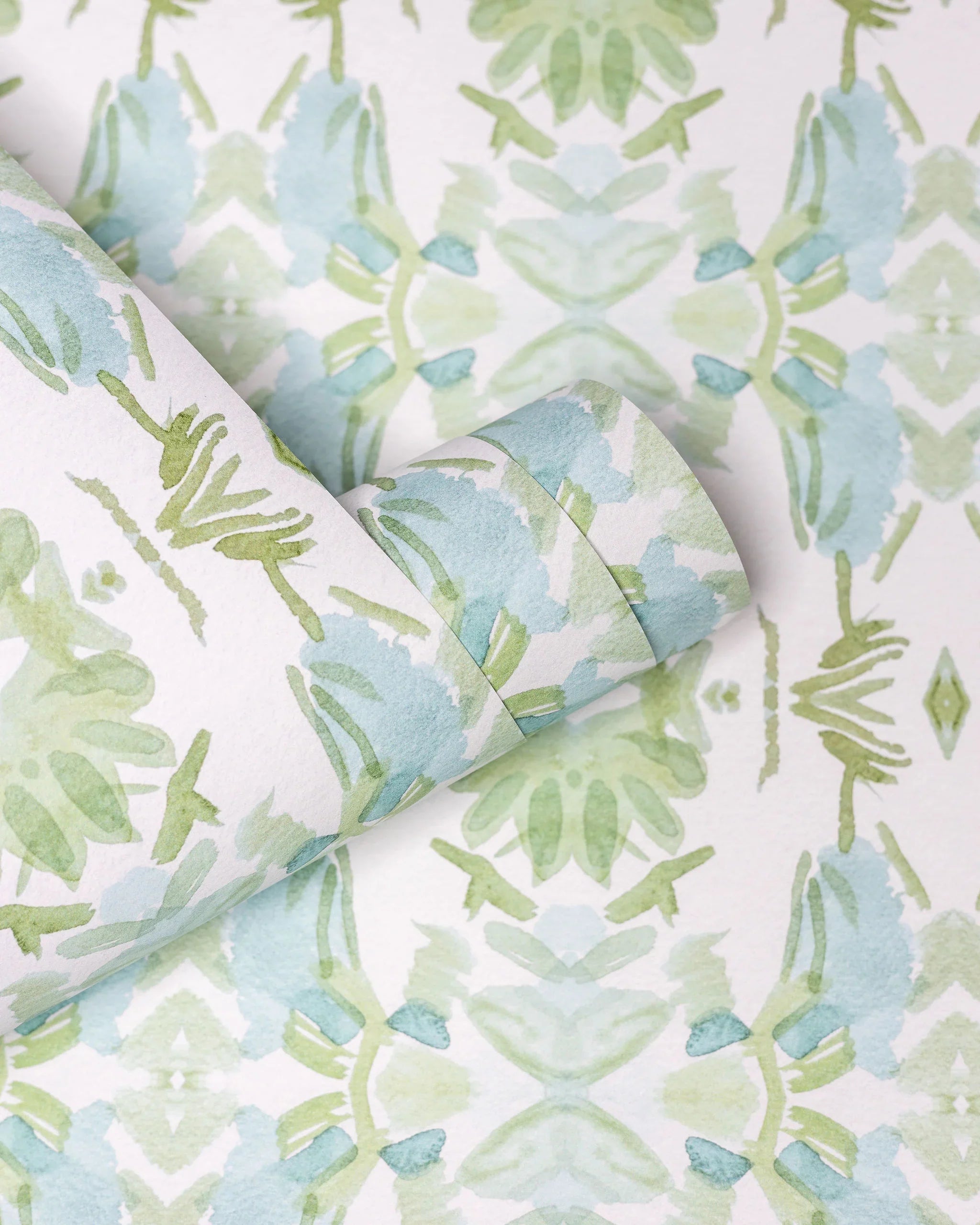 Luxury botanical wallpaper featuring an artistic wildflower-inspired pattern in sage green and soft blue, designed for modern traditional interiors, powder rooms, bedrooms, dining rooms, and collected homes.