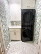Luxury botanical wallpaper featuring an artistic wildflower-inspired pattern in sage green and soft blue, designed for modern traditional interiors, powder rooms, laundry rooms, bedrooms, dining rooms, and collected homes.
