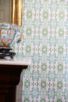 Luxury botanical wallpaper featuring an artistic wildflower-inspired pattern in sage green and soft blue, designed for modern traditional interiors, powder rooms, bedrooms, dining rooms, and collected homes.