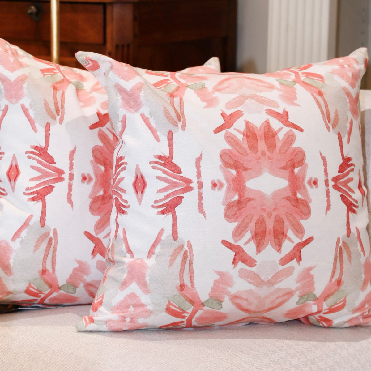 Wildflowers I Strawberry luxury decorative pillow featuring a large-scale abstract floral pattern in rich strawberry pink and red tones, handcrafted in England for luxury living rooms, designer-curated interiors, layered bedrooms, and modern traditional homes.