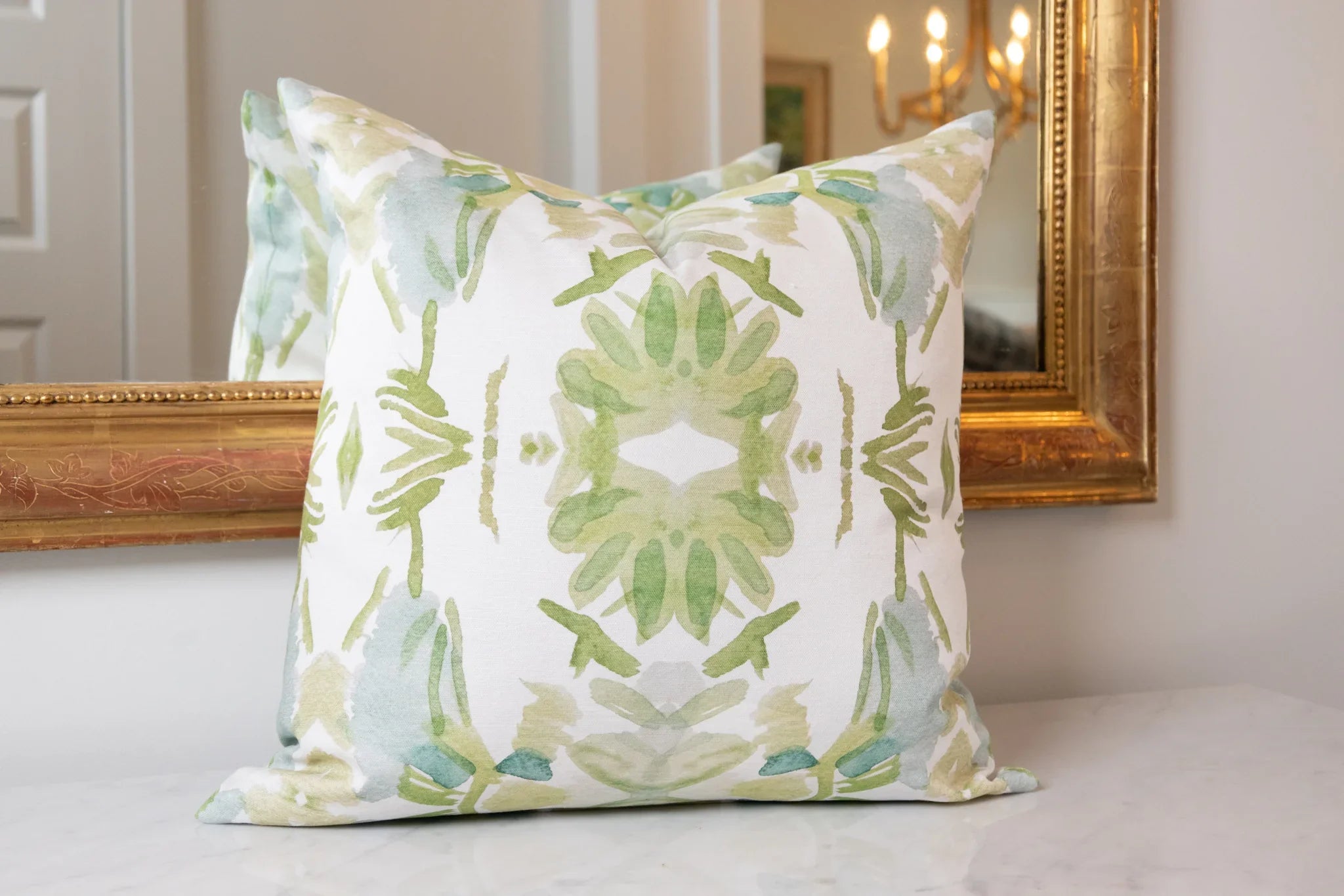 Luxury white and apple green botanical pillow with large-scale floral pattern inspired by Alaska wildflowers, handcrafted in England for contemporary and traditional interiors.