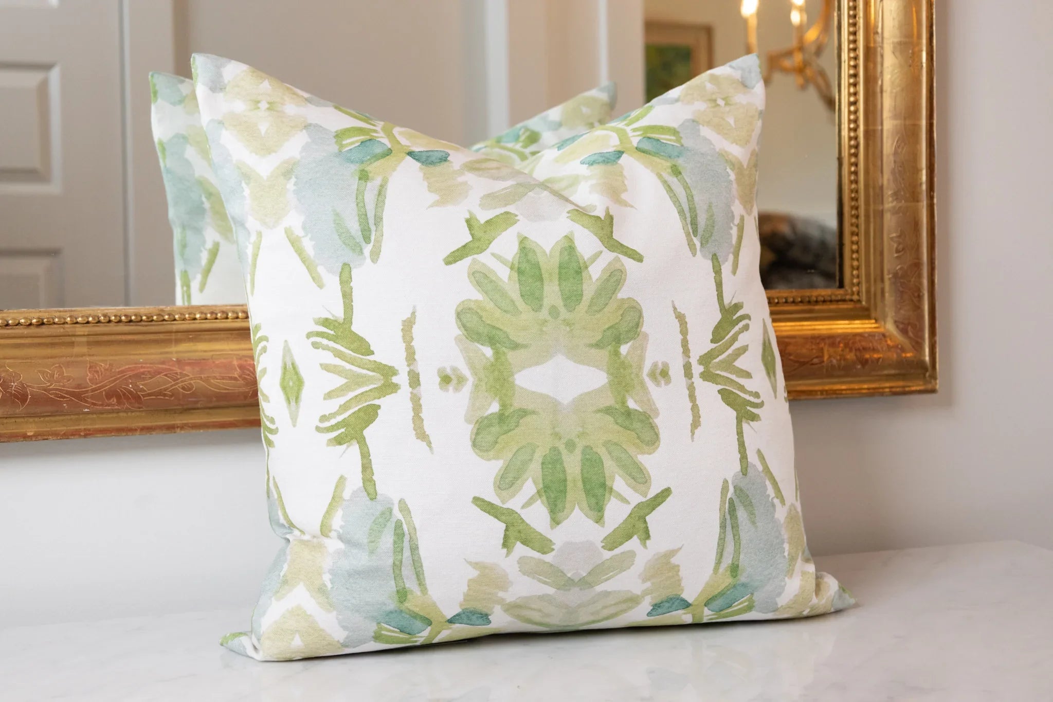 Luxury white and apple green botanical pillow with large-scale floral pattern inspired by Alaska wildflowers, handcrafted in England for contemporary and traditional interiors.