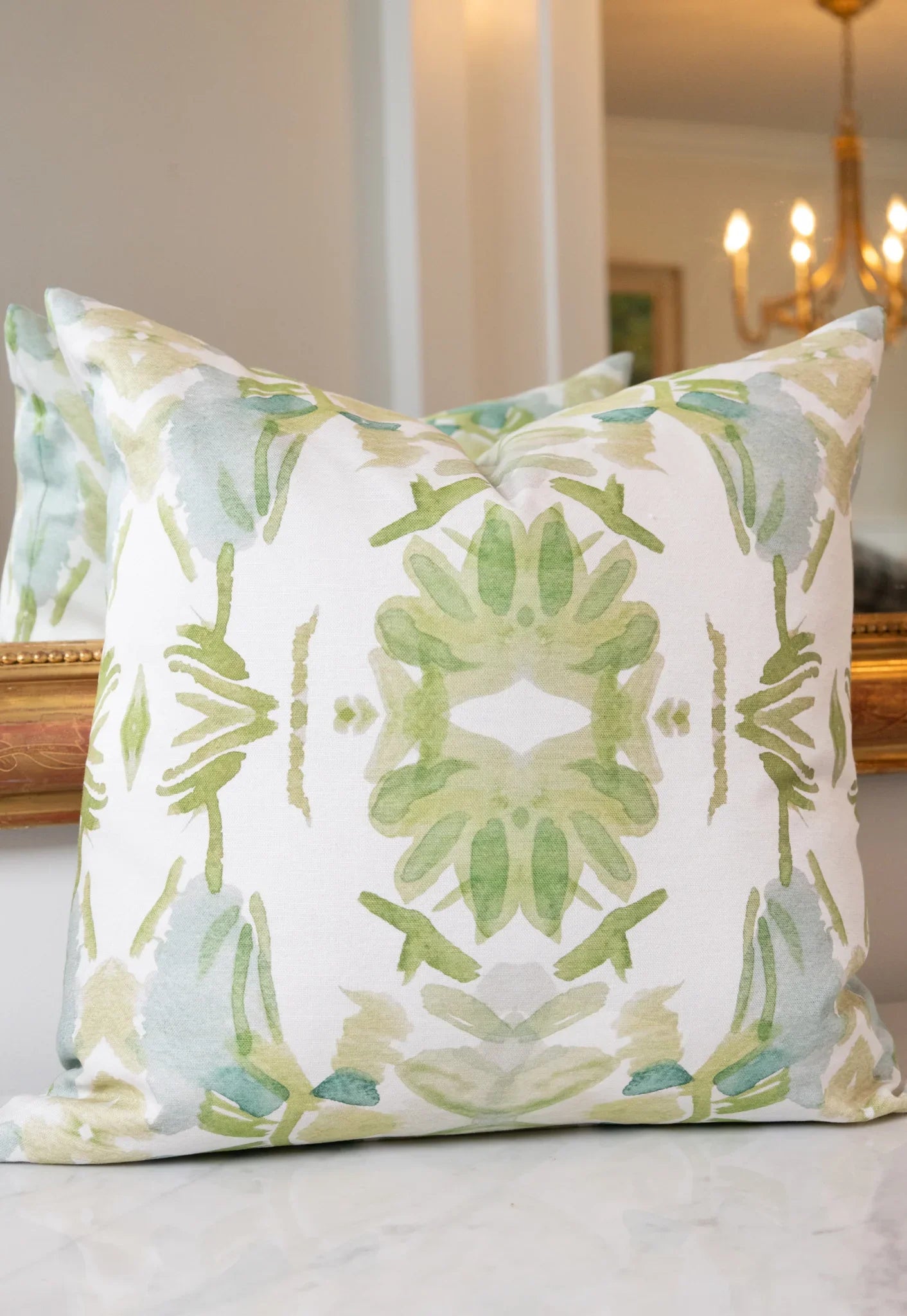 Luxury white and apple green botanical pillow with large-scale floral pattern inspired by Alaska wildflowers, handcrafted in England for contemporary and traditional interiors.