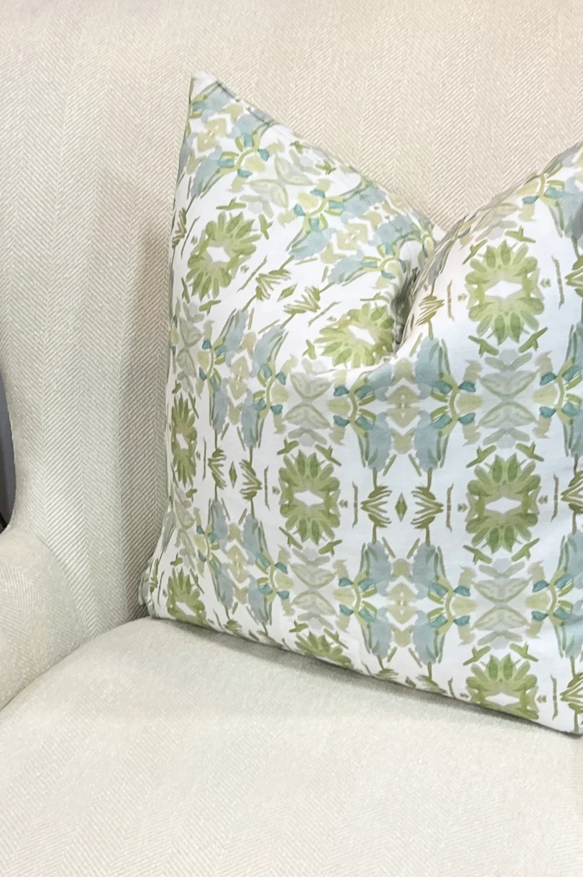 Wildflowers I White & Apple Green luxury pillow featuring an artistic floral pattern on a soft white ground, handcrafted in England for traditional, modern traditional, and layered interior design projects.