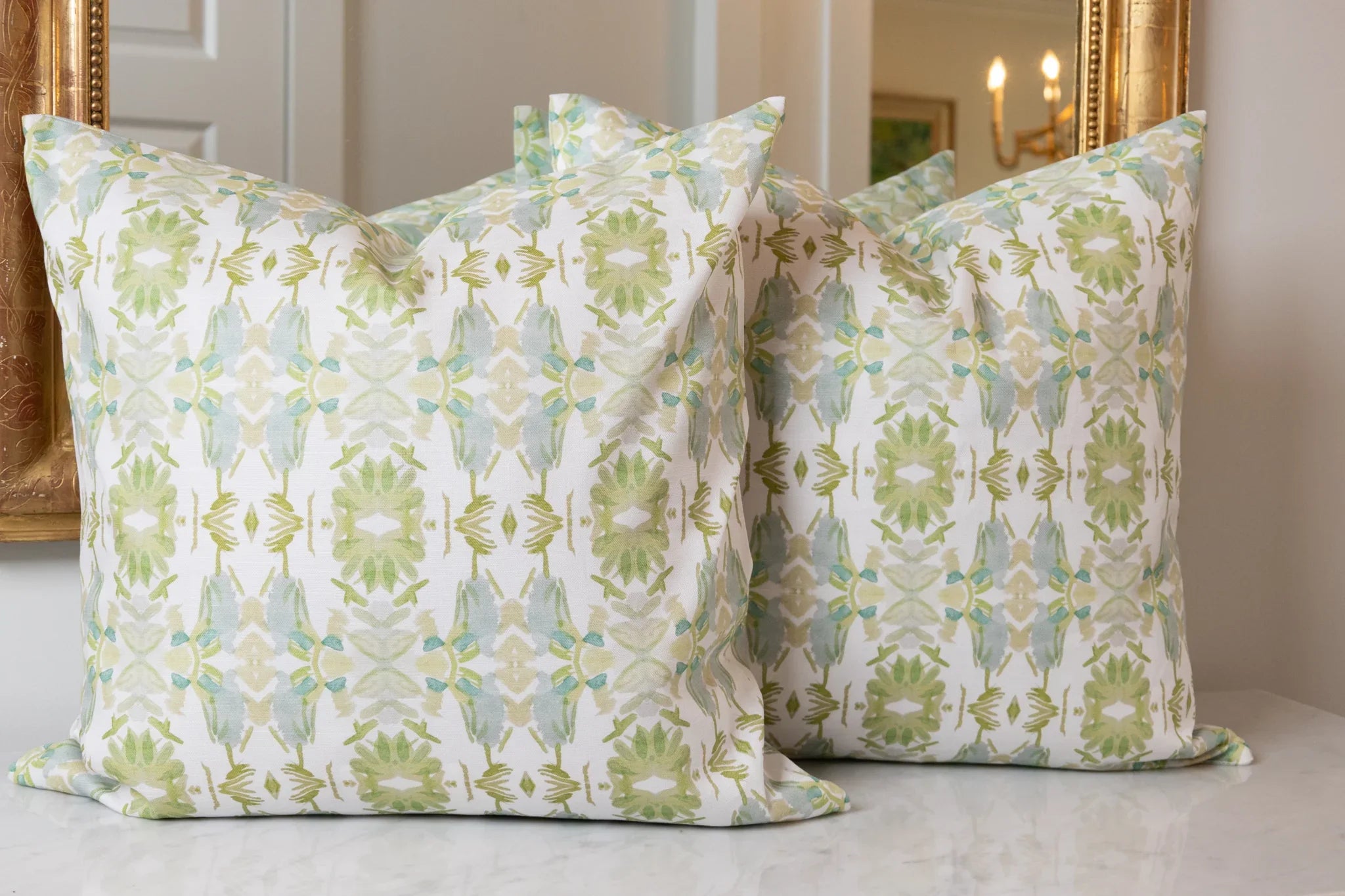 Wildflowers I White & Apple Green luxury pillow featuring an artistic floral pattern on a soft white ground, handcrafted in England for traditional, modern traditional, and layered interior design projects.