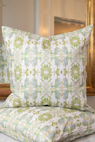 Wildflowers I White & Apple Green luxury pillow featuring an artistic floral pattern on a soft white ground, handcrafted in England for traditional, modern traditional, and layered interior design projects.