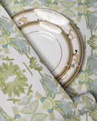 Wildflowers I White & Apple Green luxury wallpaper featuring an abstract floral pattern on a soft white ground with fresh apple green tones, sustainably printed in England for luxury homes, designer-curated interiors, powder rooms, bedrooms, and thoughtfully layered living spaces.